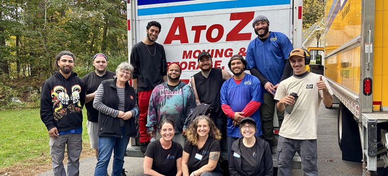 a team of movers Athol MA based in front of a moving truck 