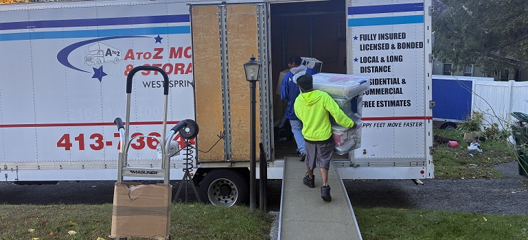two movers in Greenfield MA loading a moving truck