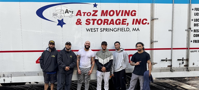 a team of movers Worcester MA based in front of a moving truck