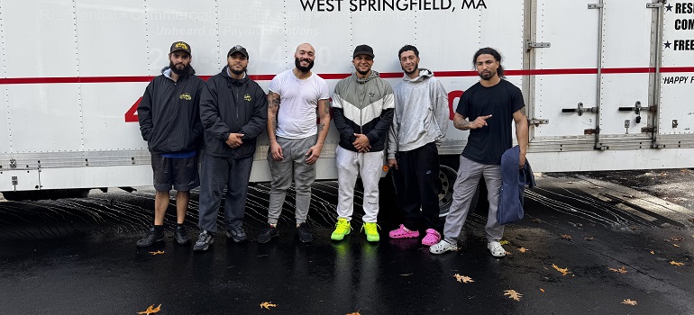a team of movers Greenfield MA based in front of a moving truck