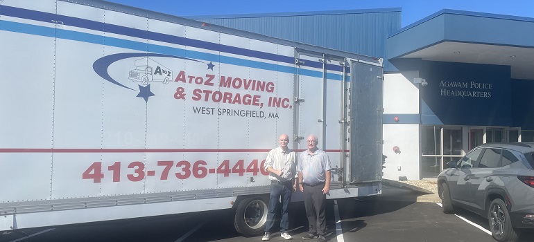 Professional mover by a branded van ready for a billiards-table job from pool table movers Massachusetts residents trust.
