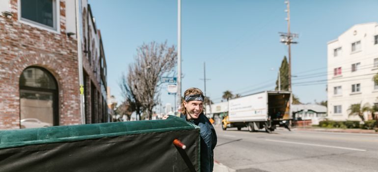 A mover carrying a sofa