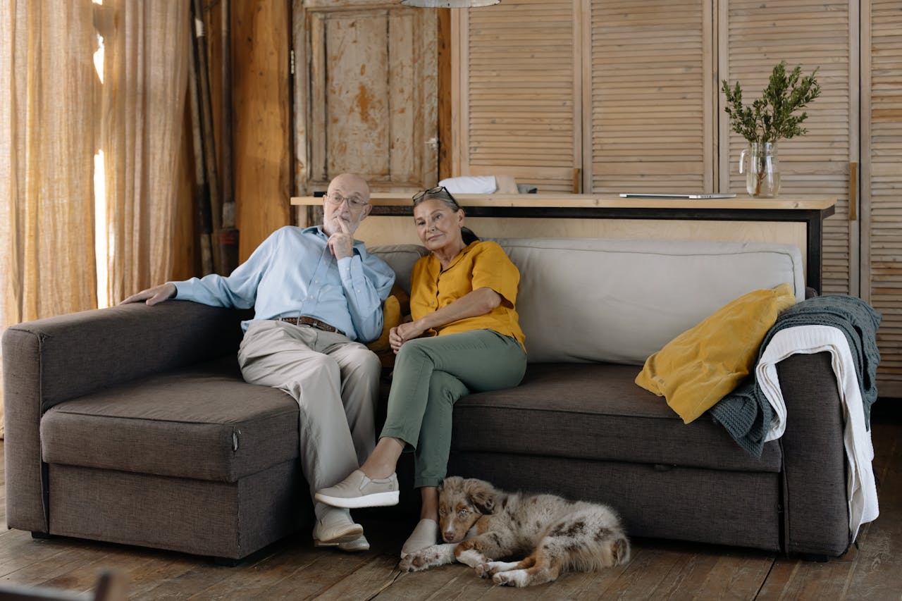 A couple relaxing on a sofa in their rented apartment