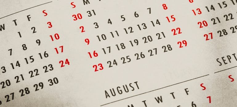 Close-up of a printed calendar showing the months of July and August