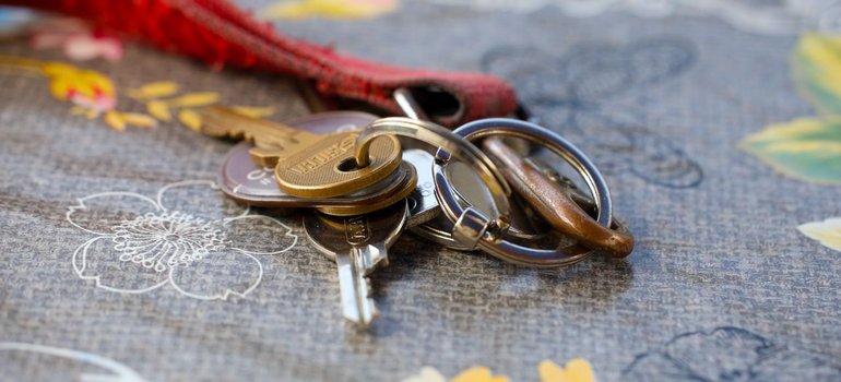 A set of apartment keys on a tablecloth, ready to be handed back to the landlord
