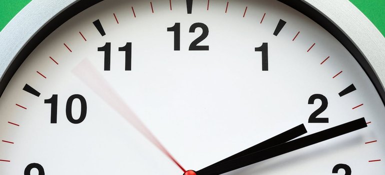Close-up of a wall clock with the second hand moving